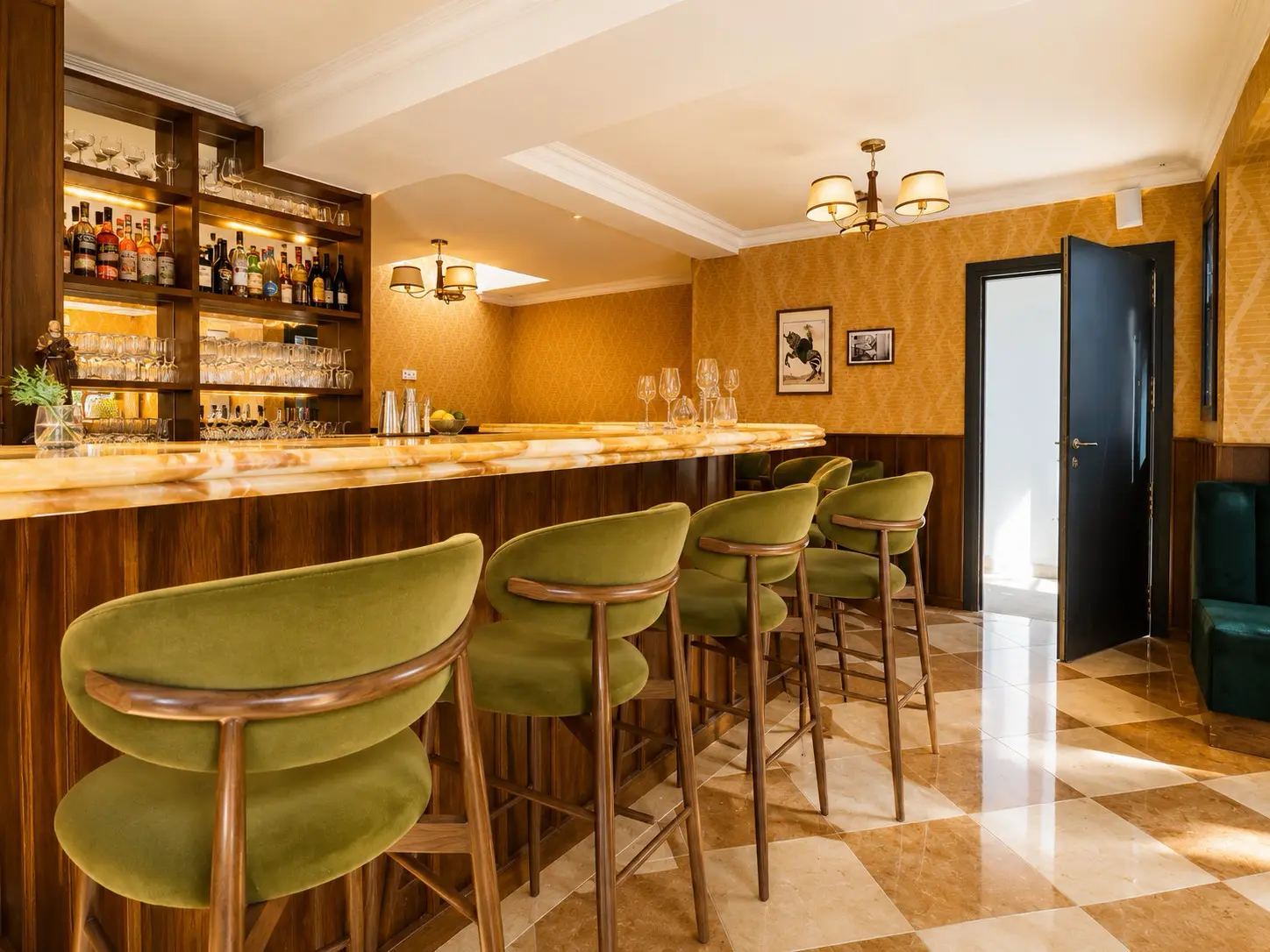 Finished boutique hotel bar with illuminated timber shelving and marble counter