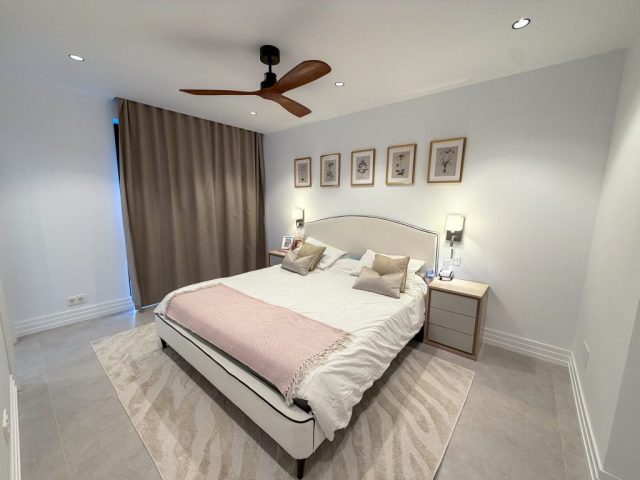 Bedroom in soft neutral tones with stone flooring
