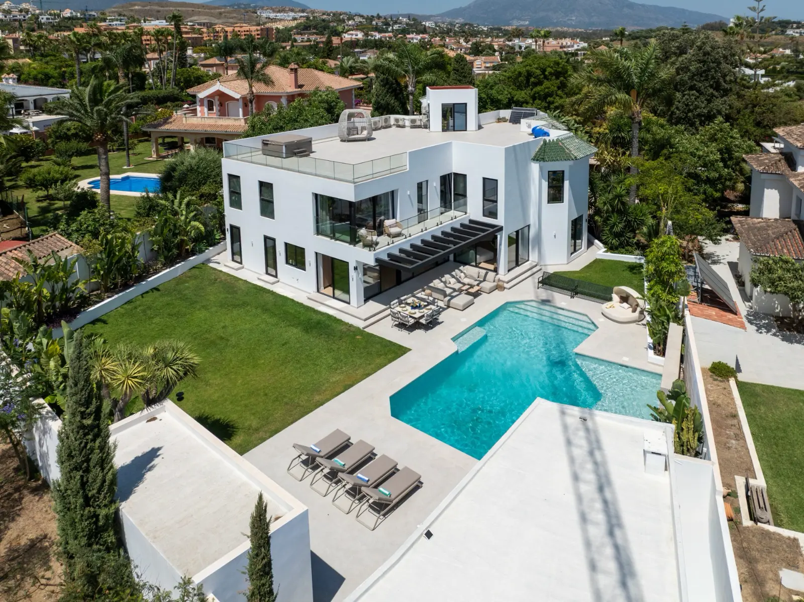 Aerial view of the pool terrace, loungers and lawn