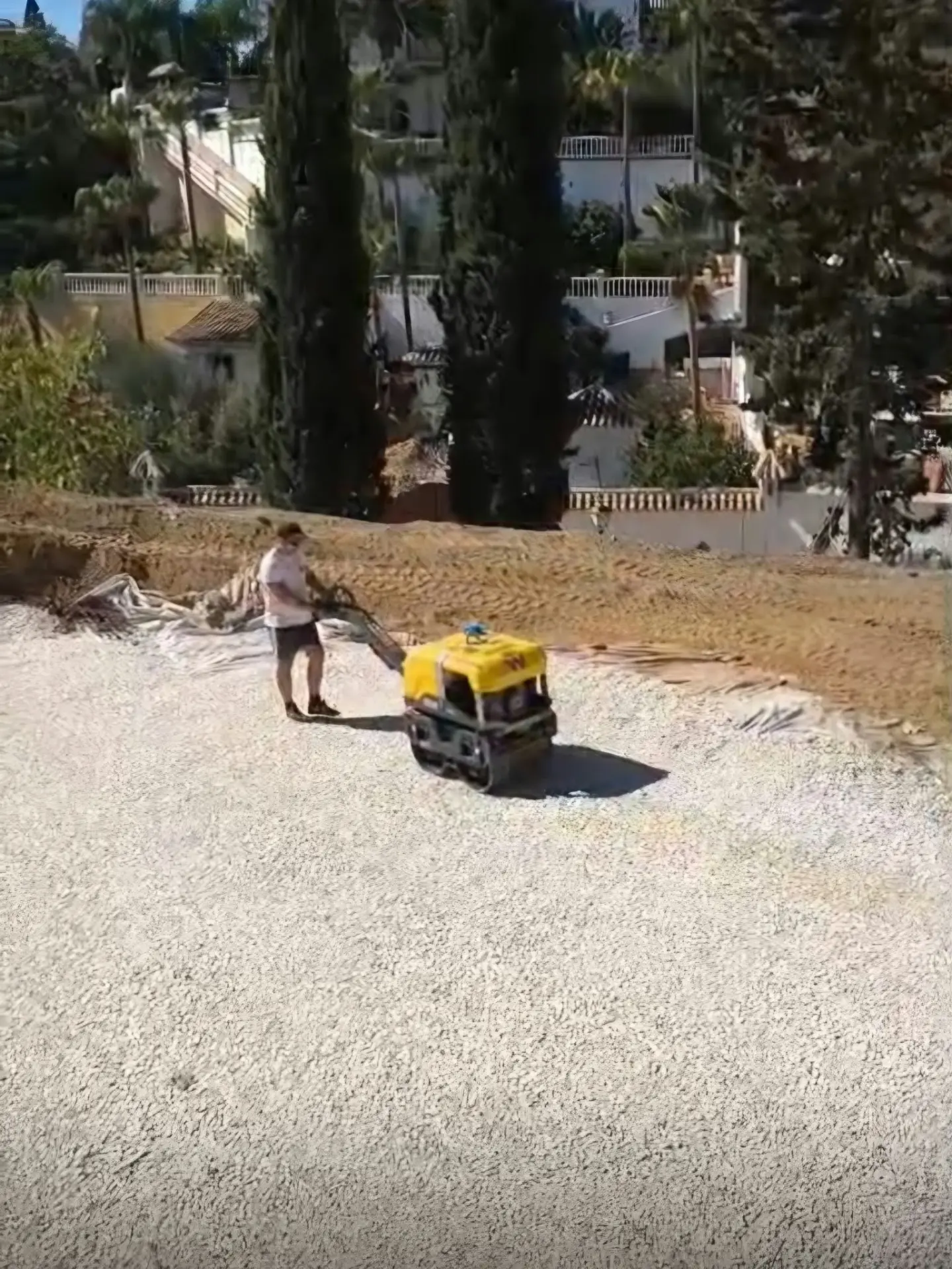 Compaction of the white aggregate bedding layer across the El Rosario building platform