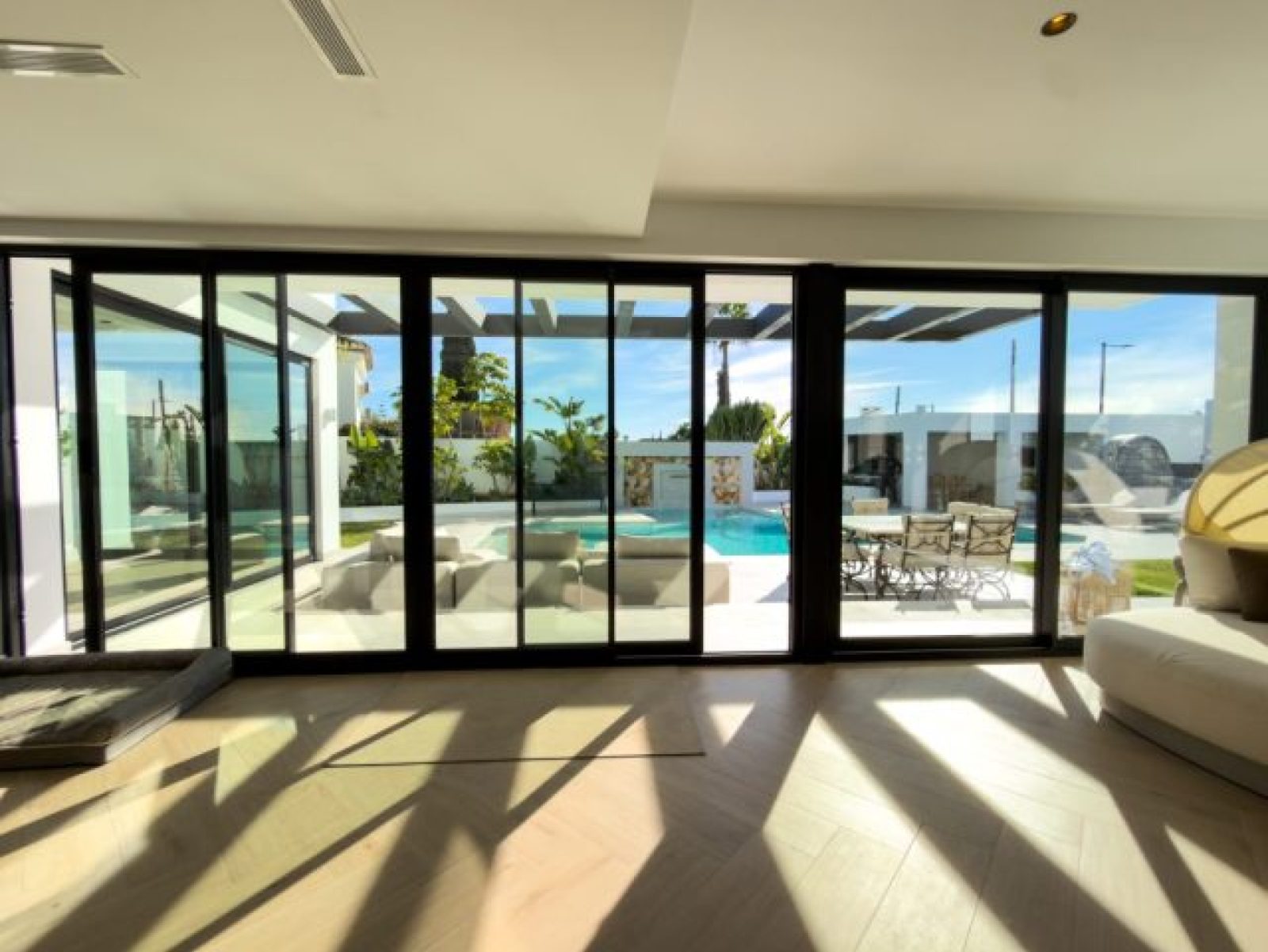 Sliding glass walls opening onto terrace