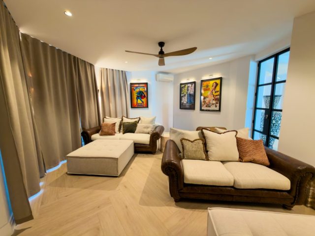 Snug lounge with herringbone oak flooring and layered lighting