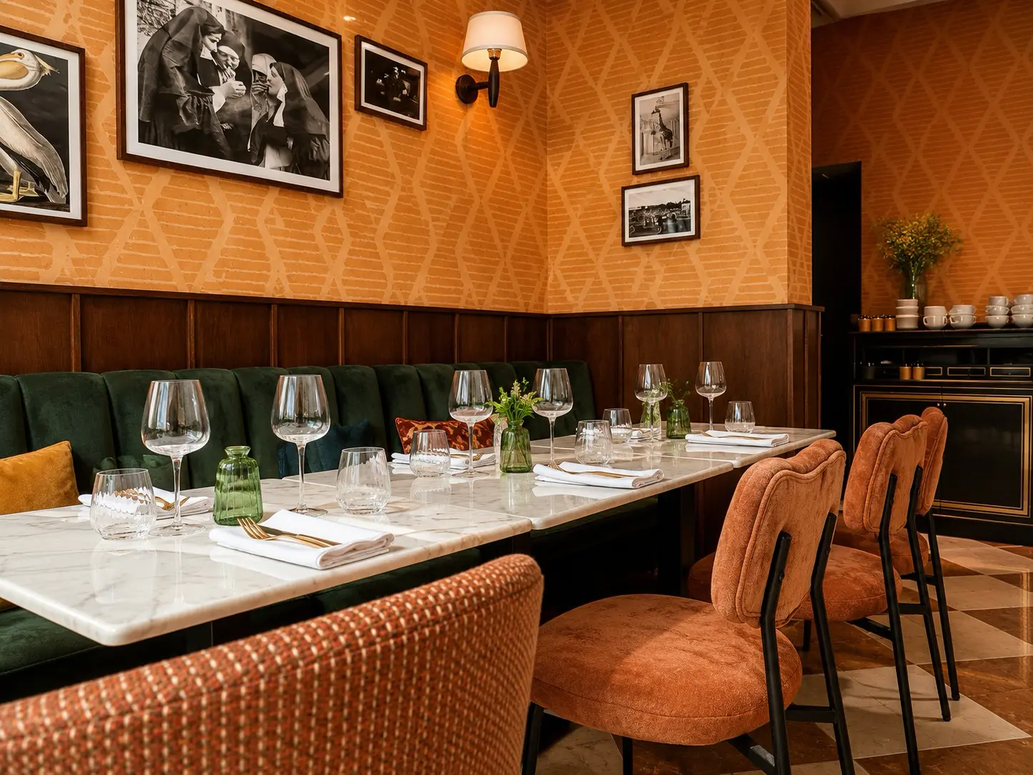 Finished boutique hotel dining room with marble tables and upholstered seating