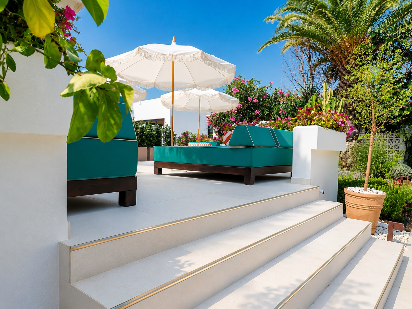 Finished boutique hotel pool terrace with green loungers and parasols