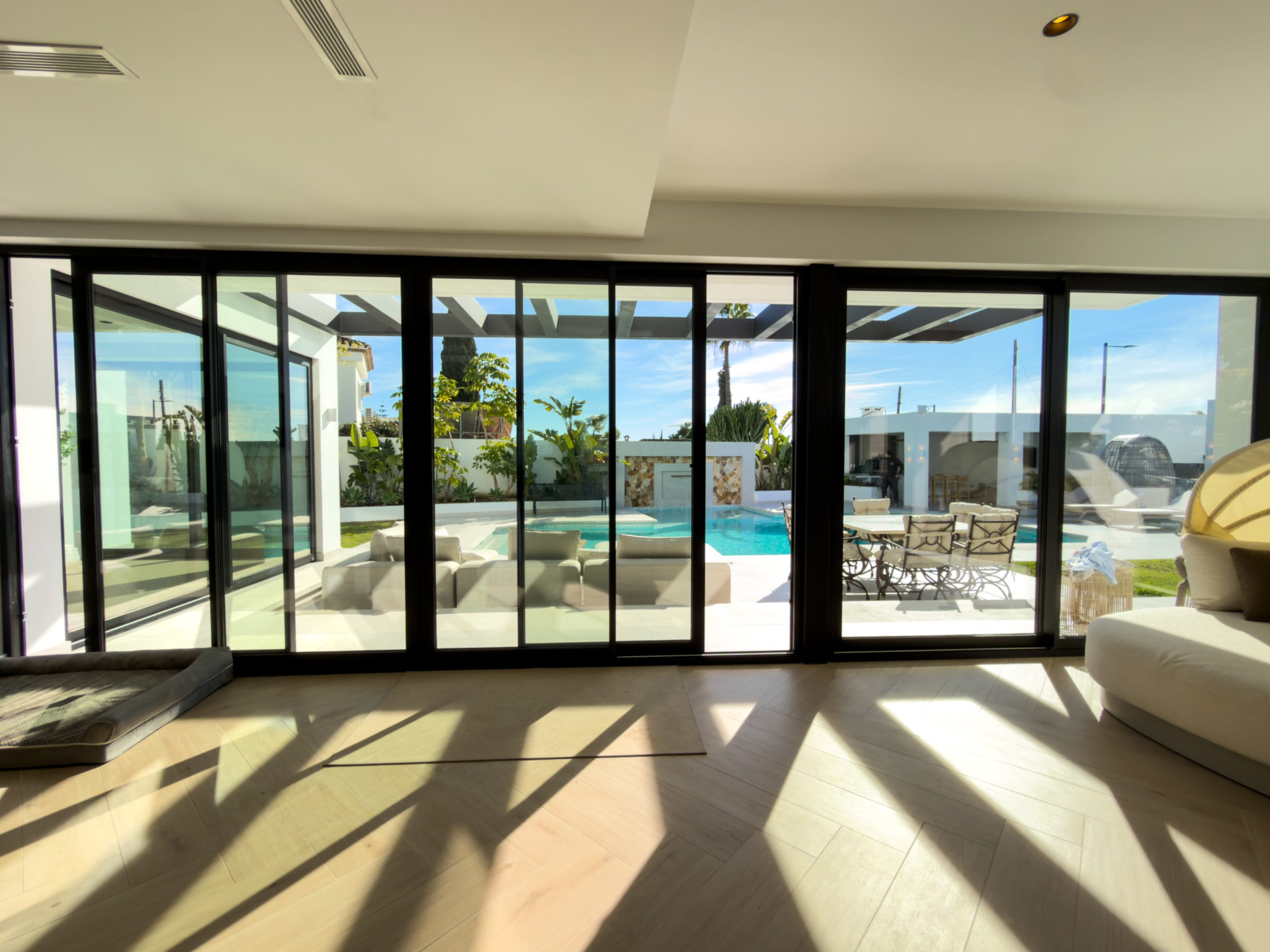 Living space with sliding glass walls onto the pool terrace